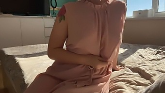 A Dainty Woman In A Pink Dress Indulges In Self-Pleasure